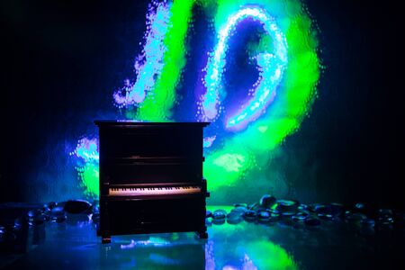 Creative concept. Artwork decoration with piano on dark toned foggy background with light. Selective focusの写真素材