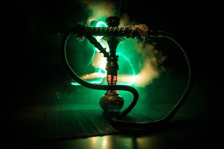Hookah hot coals on shisha bowl on dark foggy background. Stylish oriental shisha. Creative conceptの写真素材