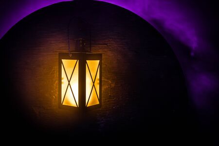 Arabic lantern with candle at night for Islamic holiday. Muslim holy month Ramadan. The end of Eid and Happy New Year. Copy space on dark background.の写真素材
