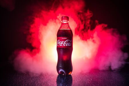 Baku, Azerbaijan - APRIL 20. 2018, Coca-Cola Classic in plastic bottle on dark toned foggy...