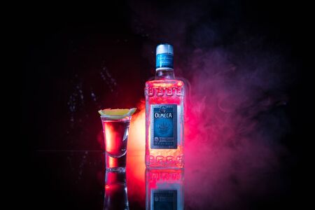 Baku, Azerbaijan - JUNE 16. 2019. Olmeca Tequila on wooden table on a dark toned foggy background. Olmeca Tequila is a tequila produced in Jalisco, Mexico. Olmeca is owned by the Pernod Ricard Group.のeditorial素材