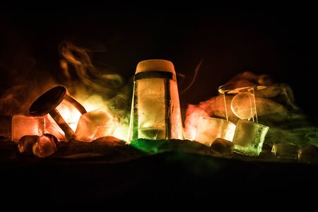 A concept of frozen time. Hourglass in ice. Creative artwork decoration. Selective focusの写真素材