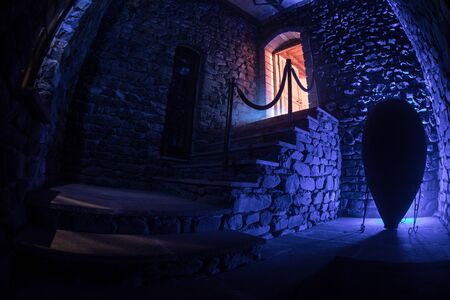 Inside of old creepy abandoned mansion. Staircase and colonnade. Dark castle stairs to the basement. Spooky dungeon stone stairs in old castle. Horror Halloween backgroundの写真素材