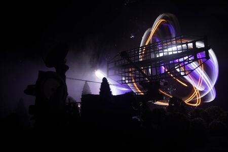 Silhouettes of satellite dishes or radio antennas against night sky. Space observatory or Air...