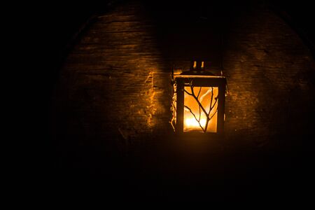 Arabic lantern with candle at night for Islamic holiday. Muslim holy month Ramadan. The end of Eid and Happy New Year. Copy space on dark background.の写真素材