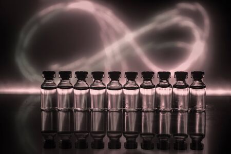 Pharmacy and chemistry theme. Test glass flask with solution in research laboratory. Science and medical background. Laboratory test tubes on dark toned background , science research equipment conceptの写真素材