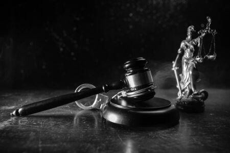 Law theme, mallet of the judge on wooden desk with Lady Justice Statue. Concept For Corruption,...