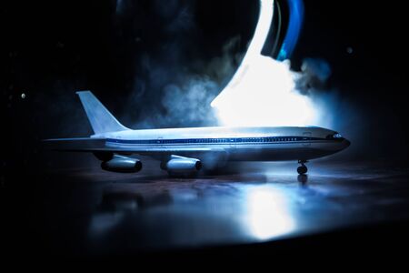 Artwork decoration. White passenger plane ready to taking off from airport runway. Silhouette of Aircraft during night time. Selective focusの写真素材