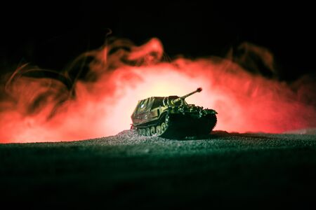 War Concept. Military silhouettes fighting scene on war fog sky background, Silhouette of armored vehicle below Cloudy Skyline At night. Attack scene. Tanks battle. Artwork decorationの写真素材