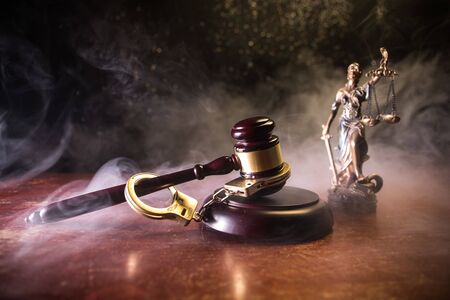 Law theme, mallet of the judge on wooden desk with Lady Justice Statue. Concept For Corruption,...