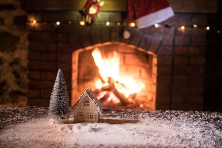 Christmas Room Interior Design, Closeup view of Christmas decorations on table with snow and fireplace on background. Empty space for your text. Selective focusの写真素材