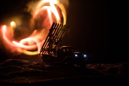 Rocket launch with fire clouds. Battle scene with rocket Missiles with Warhead Aimed at Gloomy Sky at night. Soviet rocket launcher on War Background. Creative composition.の写真素材