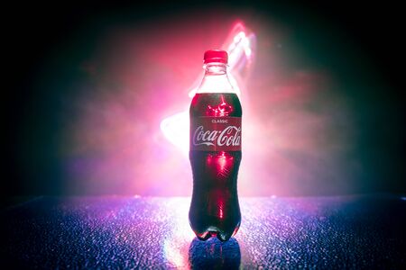 Baku, Azerbaijan - APRIL 20. 2018, Coca-Cola Classic in plastic bottle on dark toned foggy...