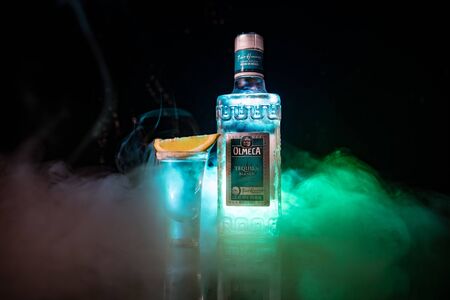 Baku, Azerbaijan - JUNE 16. 2019. Olmeca Tequila on wooden table on a dark toned foggy background. Olmeca Tequila is a tequila produced in Jalisco, Mexico. Olmeca is owned by the Pernod Ricard Group.のeditorial素材