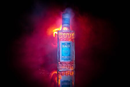 Baku, Azerbaijan - JUNE 16. 2019. Olmeca Tequila on wooden table on a dark toned foggy background. Olmeca Tequila is a tequila produced in Jalisco, Mexico. Olmeca is owned by the Pernod Ricard Group.のeditorial素材
