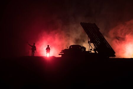 Rocket launch with fire clouds. Battle scene with rocket Missiles with Warhead Aimed at Gloomy Sky at night. Soviet rocket launcher on War Background. Creative composition.の写真素材