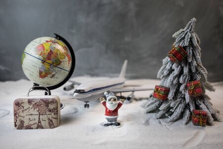 Merry Christmas and Happy new years travel concept background for winter trip. Christmas background with airplane. Creative artwork decoration on snow. Selective focus.の写真素材