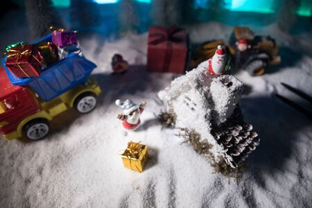 Miniature Gift Box by Forklift Machine on snow ,Determined Image for Christmas Holiday and Happy New Year Gift Celebration concept. Empty space for textの写真素材
