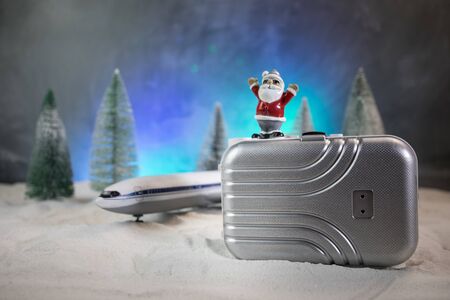 Merry Christmas and Happy new years travel concept background for winter trip. Christmas background with airplane. Creative artwork decoration on snow. Selective focus.の写真素材