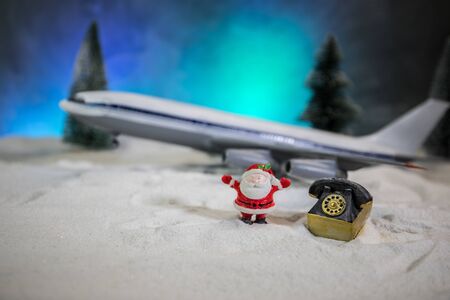 Merry Christmas and Happy new years travel concept background for winter trip. Christmas background with airplane. Creative artwork decoration on snow. Selective focus.の写真素材