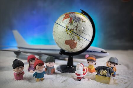 Merry Christmas and Happy new years travel concept background for winter trip. Christmas background with airplane. Creative artwork decoration on snow. Selective focus.の写真素材