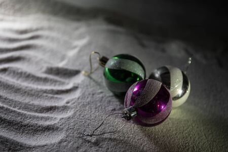 Winter holidays concept. Christmas background with baubles, on snow, free space for text. Christmas...