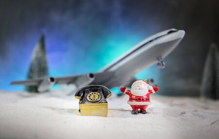 Merry Christmas and Happy new years travel concept background for winter trip. Christmas background with airplane. Creative artwork decoration on snow. Selective focus.の写真素材