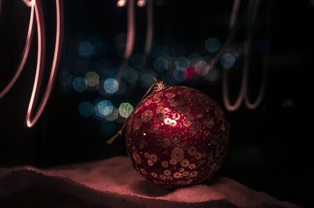 Christmas background with baubles, on snow, free space for text. Christmas decoration. Festive backgroundの写真素材