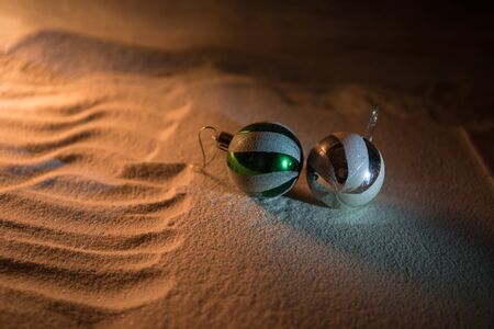 Winter holidays concept. Christmas background with baubles, on snow, free space for text. Christmas...