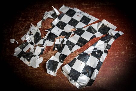 Chess board game concept of business ideas and competition. Chess figures on a dark background with broken chessboard. Creative artwork decoration. Selective focusの写真素材