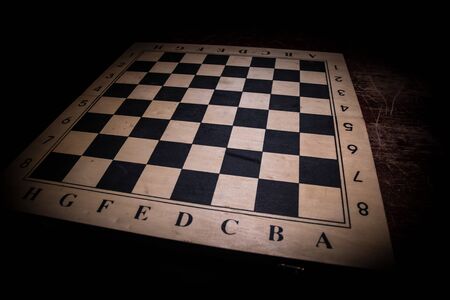 Chess board game concept of business ideas and competition. Chess figures on a dark background with...