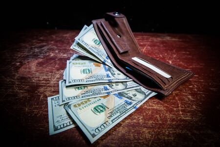 Stylish men's purse with money on wood background. men's purse with money, credit and debit cards on the wooden tableの写真素材