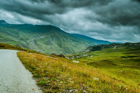 Cycling mountain road. Misty mountain road in high mountains.. Cloudy sky with mountain road....