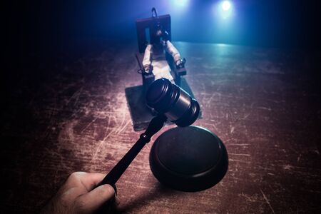 Death penalty electric chair miniature on dark. Creative artwork decoration. Image of an electric chair scale model on a dark backgorundの写真素材