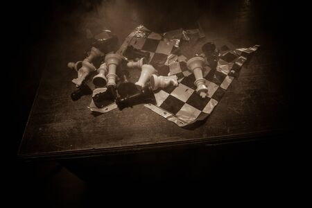 Chess board game concept of business ideas and competition. Chess figures on a dark background with broken chessboard. Creative artwork decoration. Selective focusの写真素材