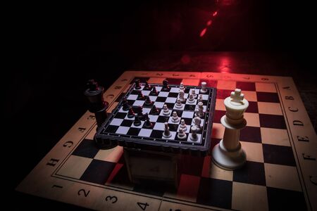 Chess board game concept of business ideas and competition. Chess figures on a dark background with smoke and fog. Selective focusの写真素材