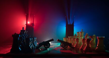Chess board game concept of business ideas and competition. Chess figures on a dark background with...