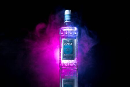 Baku, Azerbaijan - JUNE 16. 2019. Olmeca Tequila on wooden table on a dark toned foggy background. Olmeca Tequila is a tequila produced in Jalisco, Mexico. Olmeca is owned by the Pernod Ricard Group.のeditorial素材