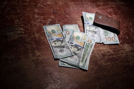 Stylish men's purse with money on wood background. men's purse with money, credit and debit cards on the wooden tableの写真素材