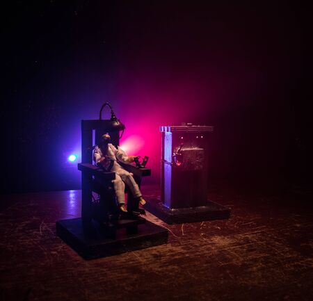 Death penalty electric chair miniature on dark. Creative artwork decoration. Image of an electric...
