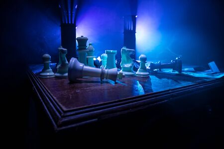 Chess board game concept of business ideas and competition. Chess figures on a dark background with broken chessboard. Creative artwork decoration. Selective focusの写真素材