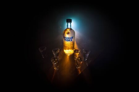 BAKU, AZERBAIJAN - FEB 09, 2020: Absolut Vodka is a brand of vodka, produced near Ahus, in Sweden. Owned by French group Pernod Ricard. Bottle of vodka on wooden table with dark toned foggy background.のeditorial素材