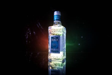Baku, Azerbaijan - JUNE 16. 2019. Olmeca Tequila on wooden table on a dark toned foggy background. Olmeca Tequila is a tequila produced in Jalisco, Mexico. Olmeca is owned by the Pernod Ricard Group.のeditorial素材