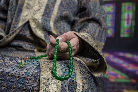 Muslim woman praying for Allah muslim god at the mosque. Hands of muslim woman on the carpet praying in traditional wearing clothes, Woman in Hijab.の写真素材