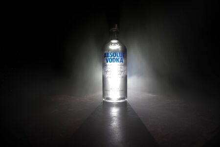 BAKU, AZERBAIJAN - FEB 09, 2020: Absolut Vodka is a brand of vodka, produced near Ahus, in Sweden. Owned by French group Pernod Ricard. Bottle of vodka on wooden table with dark toned foggy background.のeditorial素材