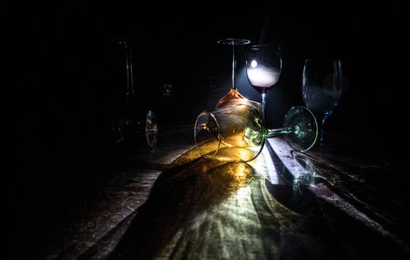 Goblet of wine on wooden table with beautiful toned lights on background. Glasses of wine on dark...