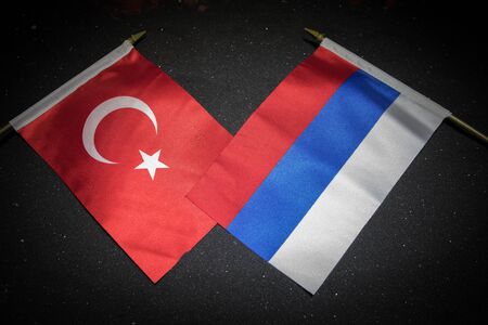 Russia and Turkey small flag on dark background. Concept of crisis of war and political conflicts between nations. Selective focusの写真素材