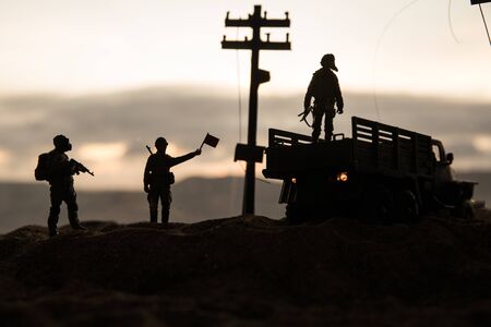 War Concept. Military silhouettes fighting scene on war fog sky background, World War Soldiers Silhouette Below Cloudy Skyline sunset. Selective focusの写真素材