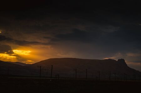 Orange sunset view at mountains in Azerbaijan. Cloudy weather. Summer time