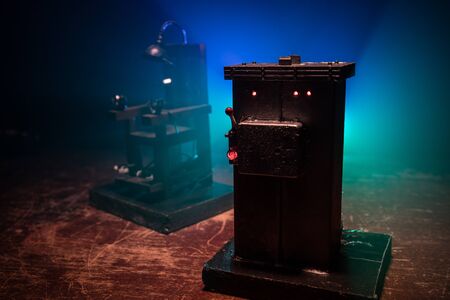 Death penalty electric chair miniature on dark. Creative artwork decoration. Image of an electric...